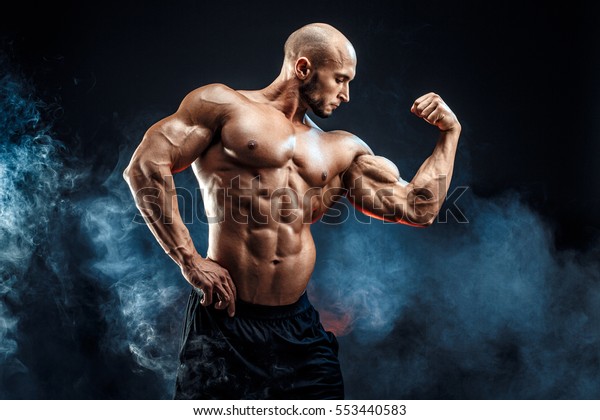 strong bald bodybuilder six pack 600w 553440583